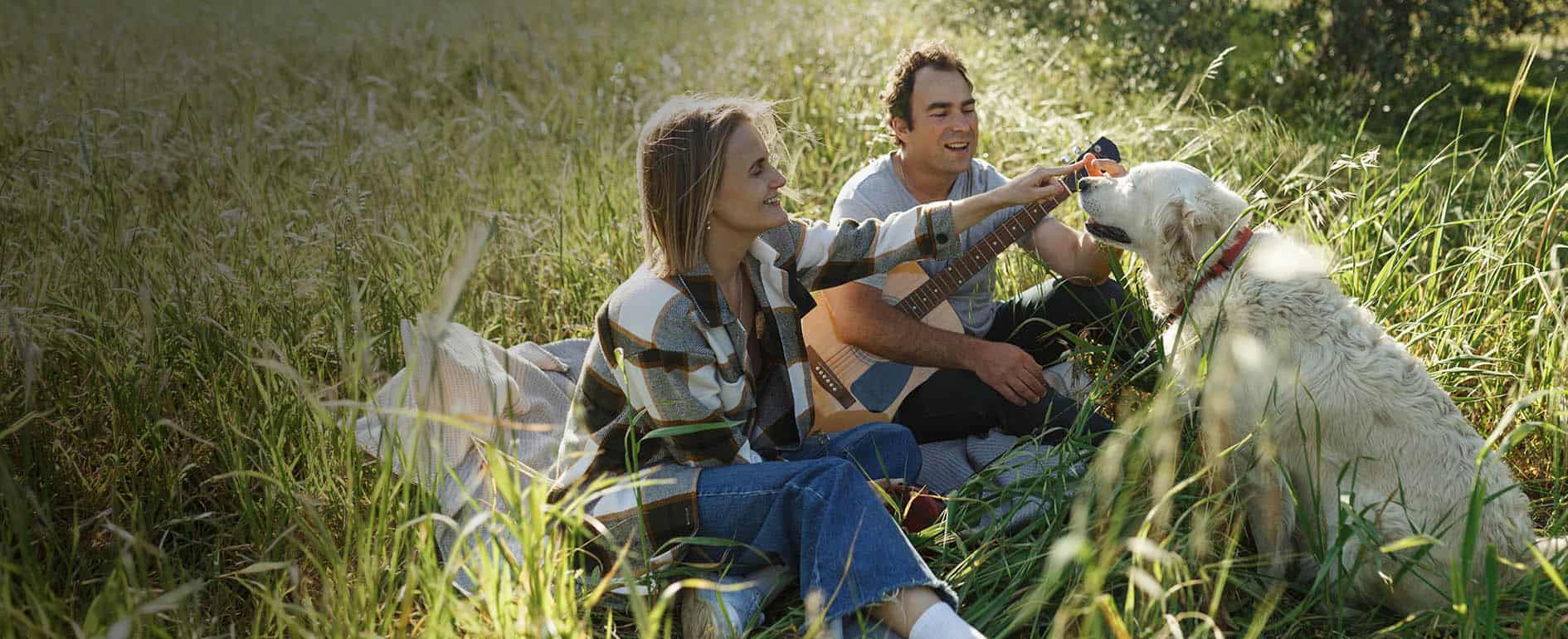 Man and woman with their dog outside