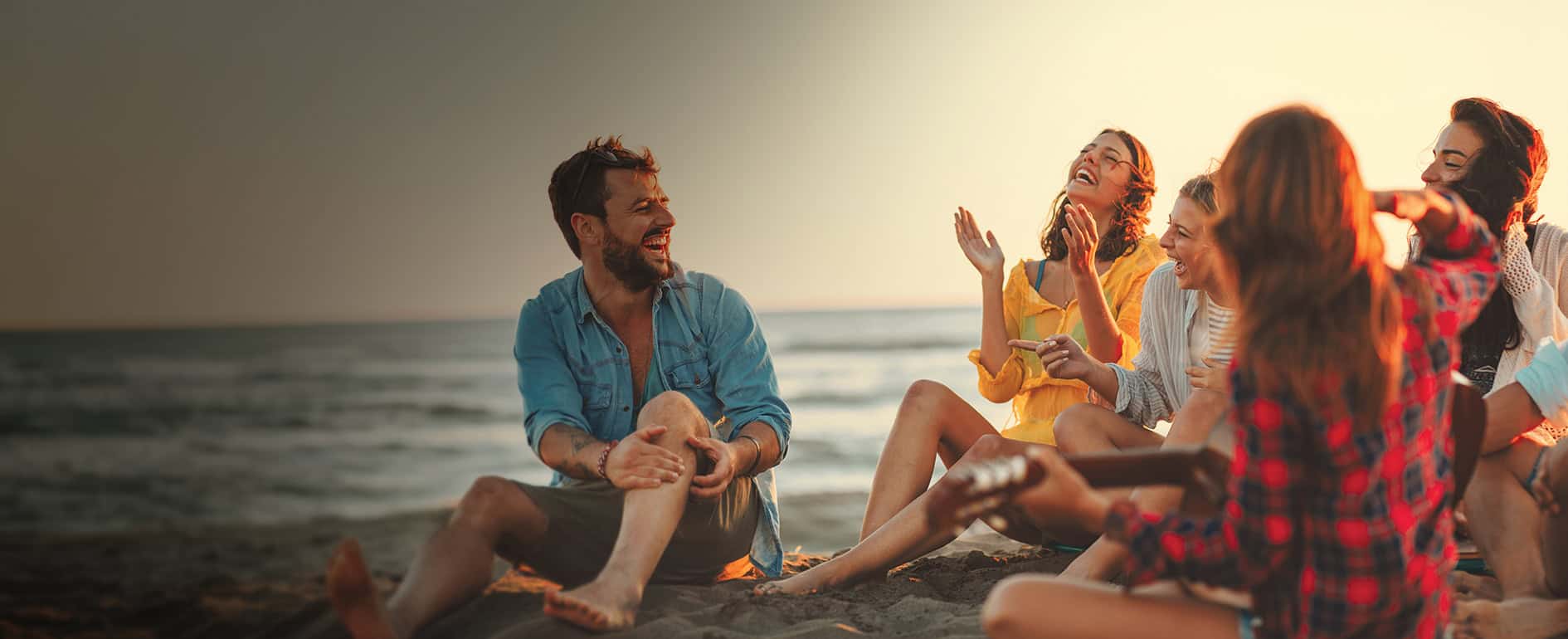 Friends enjoying a beach bonfire.