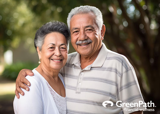 Older Hispanic couple outside smiling
