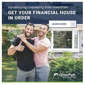 Happy couple in front of their new home.