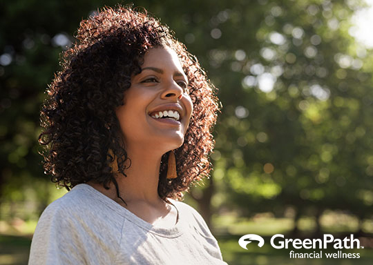 Smiling young woman enjoying a sunny day in the park