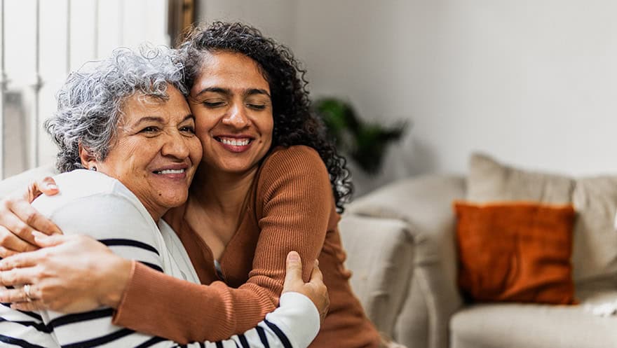 Mother and daughter embraced at home