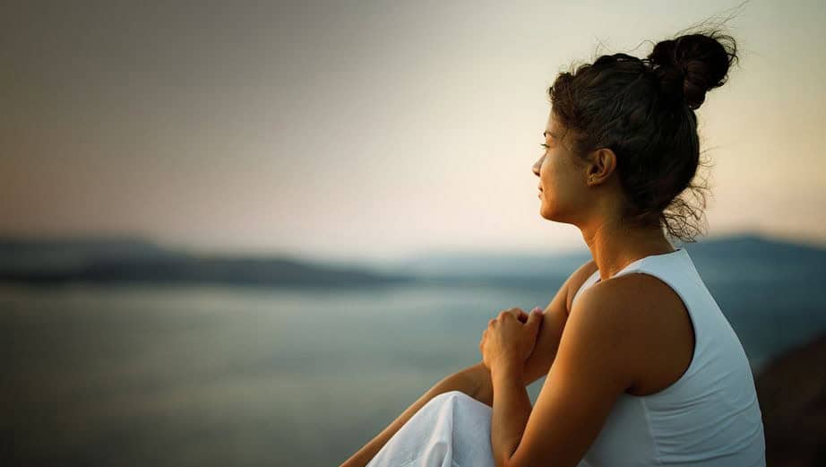 Woman sitting looking out over the water